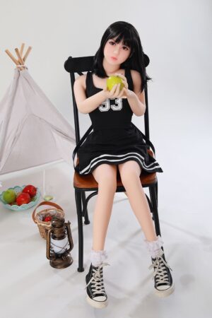 Asian young sex doll holding a green apple