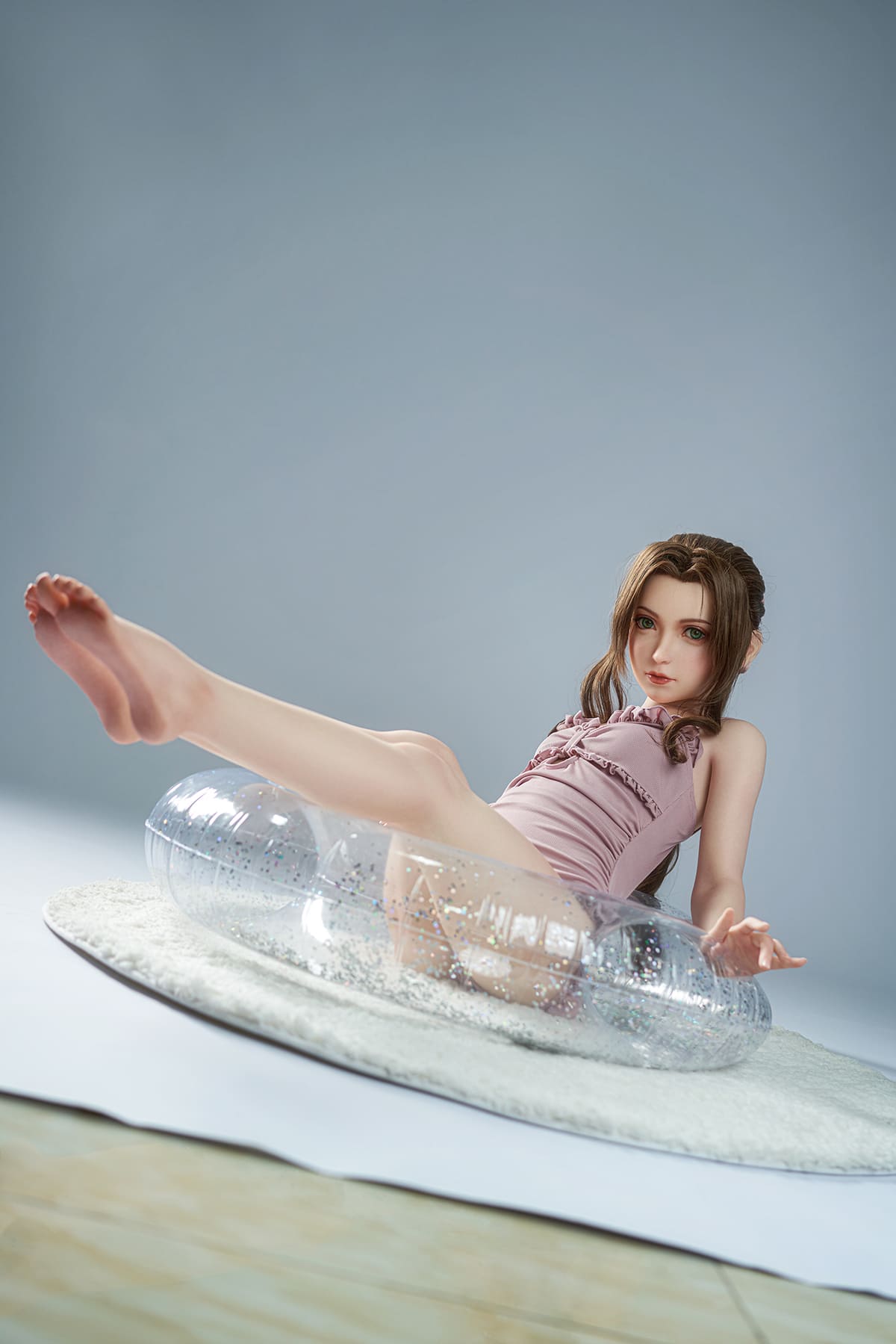 Girl Sex Doll In Purple Swimsuit Lying In Swimming Ring