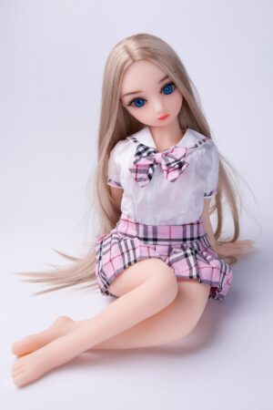 Miniature sex doll wearing a pleated school uniform