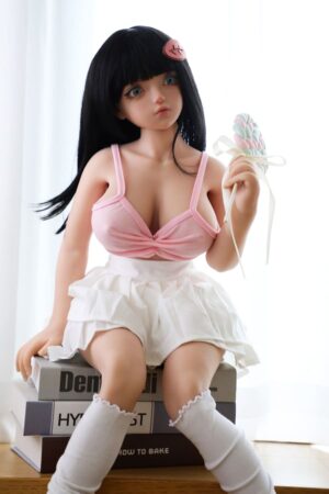 Cute Asian mini sex doll in pink bra and white pleated skirt